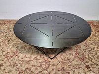 Full view of round coffee table on rug
