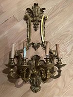 Full view of gilt bronze wall sconce front