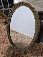 Front view of oval mirror showing full frame and glass