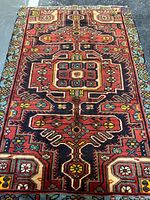 Full view of Persian Tousercan wool rug showing colors and pattern