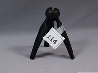 Front view of black mini tripod standing open