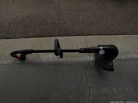 Full view of Toro string trimmer laid on concrete