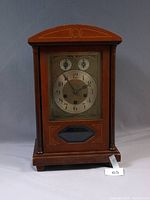 Front view of wooden Junghans mantel clock showing full case, dial, glass and overall condition