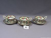 Front view of three teacup and saucer sets