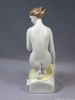 Rear view of porcelain figurine showing glaze and base