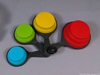 Four multicolor collapsible silicone measuring cups folded
