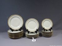 Three stacks of dinner, salad and bread plates with display samples