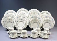 Full 40-piece place setting displayed upright showing pattern and counts