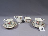 full set showing two cup and saucer sets, creamer and sugar bowl
