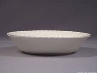 Side profile of the oval serving bowl showing depth and gold-edged rim
