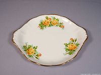 Top view of Royal Albert Yellow Tea Rose cake tray showing floral pattern and gold rim