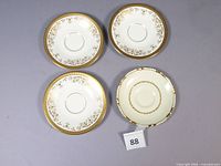 Top view of all four saucers showing patterns and quantity