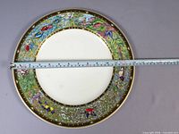 Front view of plate with tape measure showing 13-1⁄8 in diameter