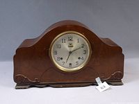 Front view showing dial, bezel and wood case