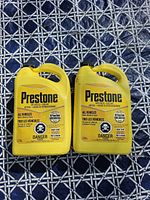 Front view of both Prestone antifreeze jugs showing labeling and volumes