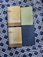 Four books laid out showing covers and spines