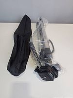 Tripod and carry bag on table, plastic wrap intact