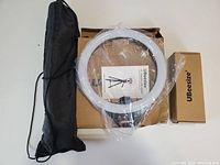 All kit components in packaging: ring light, tripod bag, boxes
