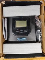 Controller inside protective foam within box, showing LCD and Rover 40A marking