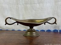 side profile showing bowl shape, handles, pedestal