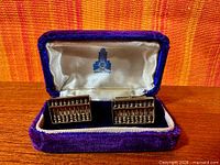 Cufflinks in open velvet box front view