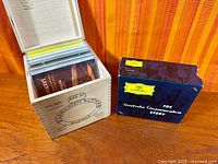 Open wooden box showing multiple classical CDs
