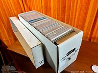 Two cardboard long boxes filled with bagged comics