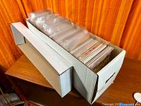 Long white comic long-box filled with bagged comics