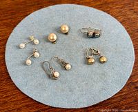 All earrings laid out showing quantity, styles and colours