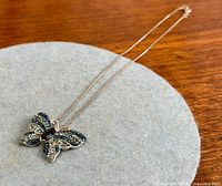 Full view of necklace showing butterfly pendant and chain
