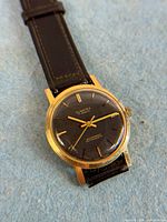 Front view showing dial, case, and strap