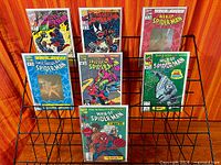 Front view of rack with seven bagged Spider-Man comics