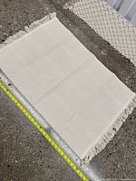 Full view of rug with tape measure showing width