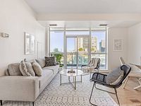 Rug shown covering living room floor beneath sofa, chairs, coffee table