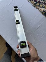 Oblique view showing aluminum body with two vials visible