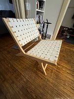 Side view of wooden strap lounge chair