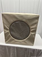 front view of cream cube showing circular opening with striped drum inserted