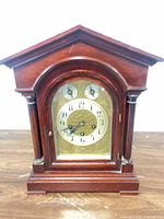 Front view of wooden mantel clock showing case design