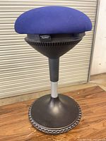 Full view of stool showing seat, column, and base