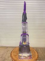 Full upright view of carpet cleaner showing handle, tanks, base