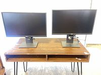 Front view of two Dell monitors on stands