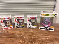 Group shot of four boxed Funko Pop figures on table