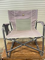 Full front view of GCI Outdoor Freestyle Rocker XL folding chair on wooden surface