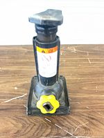 Front view of screw jack showing body, base and yellow knob