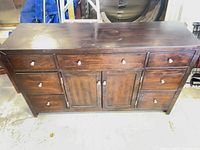 Front view showing seven drawers, two cabinet doors, overall structure