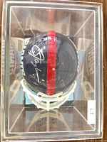Top view of signed mini helmet inside case