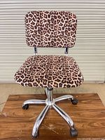 Front view of leopard print office chair showing seat, backrest and chrome base