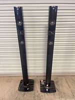 Full view of both LG tower speakers on bases