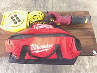 Overview of reciprocating saw, cord reel with extension cord and Milwaukee tool bag