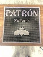 Front view showing Patrón XO Cafe text, bee logo, textured surface